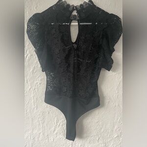 Valentine black lace thong bodysuit, high neck, front opening, elbow sleeves; M